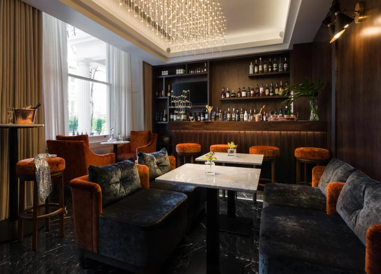 a restaurant with a table and chairs and a bar at Montcalm Chilworth Townhouse in London