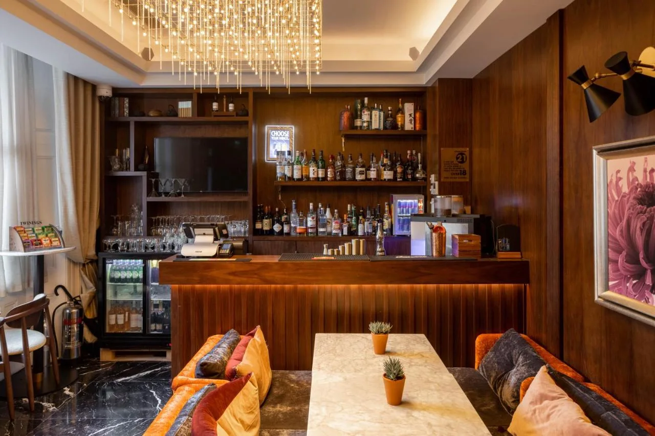 a bar in a restaurant with a table and chairs at Montcalm Chilworth Townhouse in London
