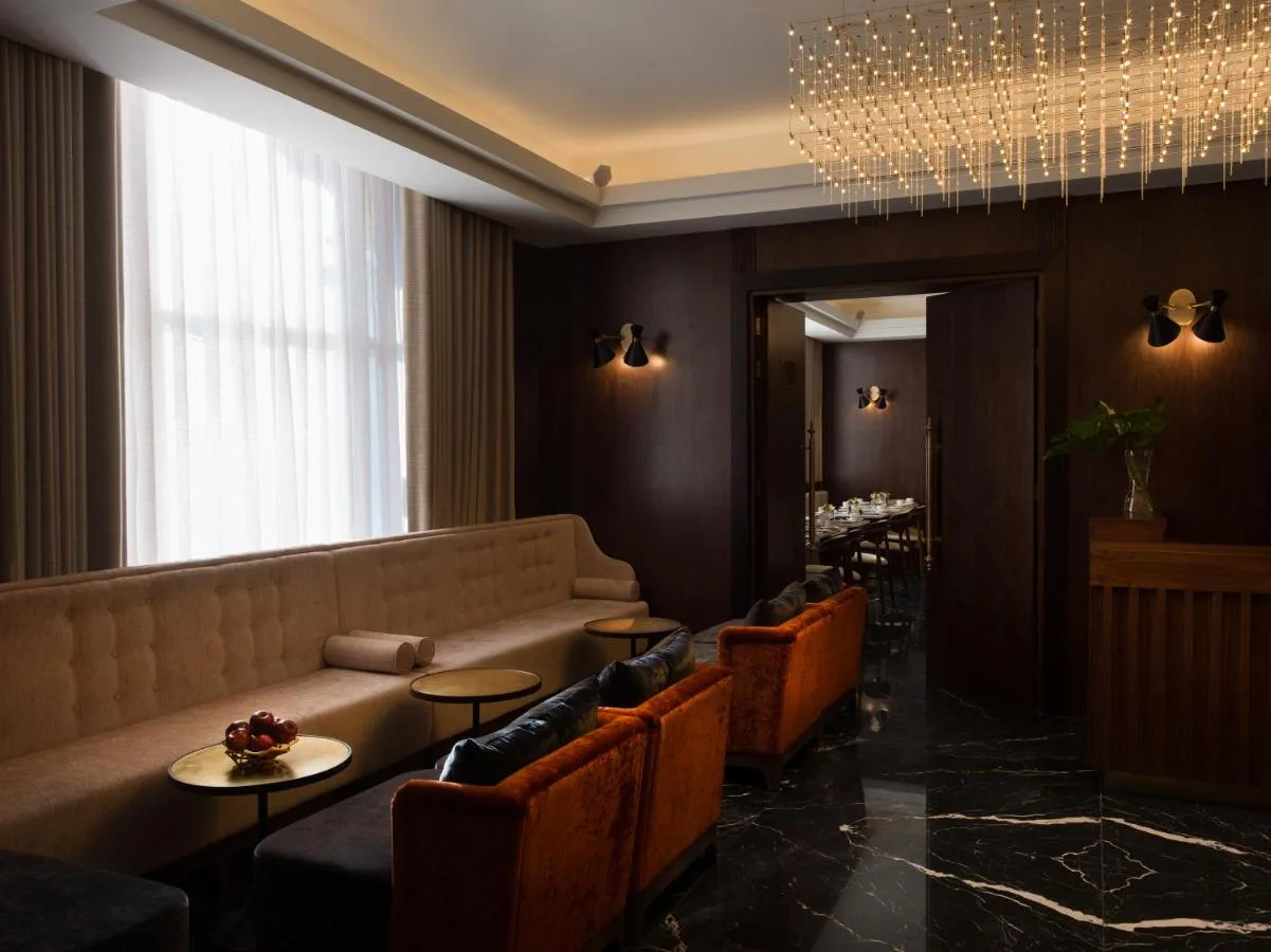 a restaurant with a couch and tables and chairs at Montcalm Chilworth Townhouse in London